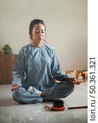 woman meditating with singing bowl incense. Стоковое фото, агентство Ingram Publishing / Фотобанк Лори