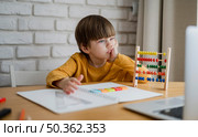 front view child with abacus learning from laptop home. Стоковое фото, агентство Ingram Publishing / Фотобанк Лори