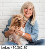 medium shot happy woman holding dog. Стоковое фото, агентство Ingram Publishing / Фотобанк Лори