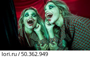 multiple mirror effect woman having creepy laugh. Стоковое фото, агентство Ingram Publishing / Фотобанк Лори