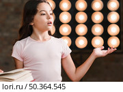 girl performing front stage light. Стоковое фото, агентство Ingram Publishing / Фотобанк Лори
