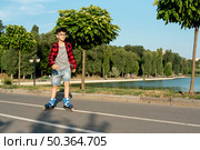 long shot boy with blue inline skates. Стоковое фото, агентство Ingram Publishing / Фотобанк Лори