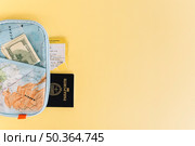 map wallet with currency passport ticket yellow background. Стоковое фото, агентство Ingram Publishing / Фотобанк Лори