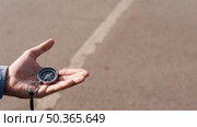close up man s hand holding navigational compass street. Стоковое фото, агентство Ingram Publishing / Фотобанк Лори