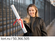medium shot girl smiling holding her certificate. Стоковое фото, агентство Ingram Publishing / Фотобанк Лори