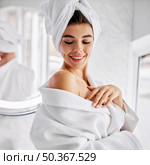 young woman wearing bathrobe towel her hair. Стоковое фото, агентство Ingram Publishing / Фотобанк Лори