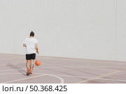 rear view young man praticing basketball. Стоковое фото, агентство Ingram Publishing / Фотобанк Лори