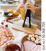 close up hand grating cheese kitchen. Стоковое фото, агентство Ingram Publishing / Фотобанк Лори