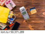 gift boxed wristwatch mobile phone payment terminal bank card wooden table. Стоковое фото, агентство Ingram Publishing / Фотобанк Лори