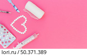 heart shape made with pills gauze syringe scalpel medicine blister pack pink background. Стоковое фото, агентство Ingram Publishing / Фотобанк Лори