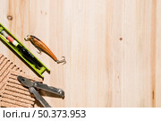 fishing lure fishing float corkboard plier desk. Стоковое фото, агентство Ingram Publishing / Фотобанк Лори