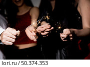 ladies guy holding burning bengal lights. Стоковое фото, агентство Ingram Publishing / Фотобанк Лори