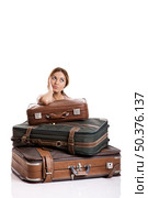 Beautiful young woman behind the baggage thinking on the vacations, isolated on white background. Стоковое фото, агентство Ingram Publishing / Фотобанк Лори
