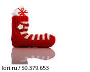 A red Christmas Sock with gift isolated on white background with reflection. Стоковое фото, агентство Ingram Publishing / Фотобанк Лори