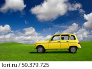 Yellow classic car in a green meadow. Стоковое фото, агентство Ingram Publishing / Фотобанк Лори