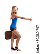 Beautiful young woman hitch hiking with old leather suitcase, isolated on white. Стоковое фото, агентство Ingram Publishing / Фотобанк Лори