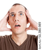 Stressed young man frustrated with something, isolated on white. Стоковое фото, агентство Ingram Publishing / Фотобанк Лори