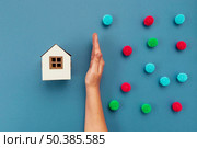 top view hand separating decorative balls paper house. Стоковое фото, агентство Ingram Publishing / Фотобанк Лори