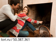 man looking young woman ignite big match fireplace. Стоковое фото, агентство Ingram Publishing / Фотобанк Лори