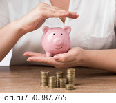 piggy bank with piles coins. Стоковое фото, агентство Ingram Publishing / Фотобанк Лори