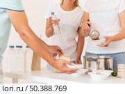 volunteers handing bowl donated food needy person. Стоковое фото, агентство Ingram Publishing / Фотобанк Лори
