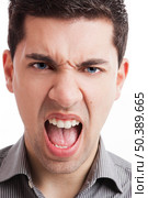 Portrait of a angry young man yelling, isolated on white background. Стоковое фото, агентство Ingram Publishing / Фотобанк Лори