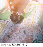 close up female s hand holding navigational compass map. Стоковое фото, агентство Ingram Publishing / Фотобанк Лори