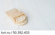 homemade crispy puffed rice brown paper bag white wooden desk. Стоковое фото, агентство Ingram Publishing / Фотобанк Лори