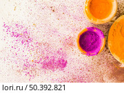 pink yellow holi powder bowl with stained white background. Стоковое фото, агентство Ingram Publishing / Фотобанк Лори