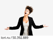 Business woman trying to catch something falling from the sky, isolated over a gray brackground. Стоковое фото, агентство Ingram Publishing / Фотобанк Лори