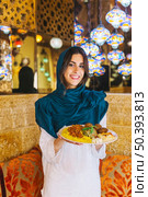 woman holding dish arab food. Стоковое фото, агентство Ingram Publishing / Фотобанк Лори