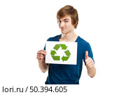 Casual young man holding a recycling sign to promote a green and better world, isolated on white background. Стоковое фото, агентство Ingram Publishing / Фотобанк Лори