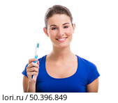 Beautiful woman with a great smile holding toothbrush, isolated over a white background. Стоковое фото, агентство Ingram Publishing / Фотобанк Лори
