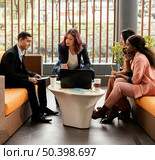full shot woman leading meeting indoors. Стоковое фото, агентство Ingram Publishing / Фотобанк Лори