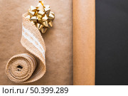 ribbon bow weaving ribbon rolled up brown paper black background. Стоковое фото, агентство Ingram Publishing / Фотобанк Лори