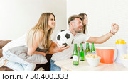 company friends rejoicing watching football tv. Стоковое фото, агентство Ingram Publishing / Фотобанк Лори