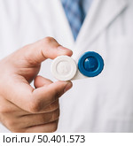 OLYMPUS DIGITAL CAMERA. doctor holding contact lenses case his hand. Стоковое фото, агентство Ingram Publishing / Фотобанк Лори
