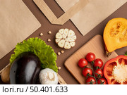 flat lay basket organic vegetables with paper bag. Стоковое фото, агентство Ingram Publishing / Фотобанк Лори