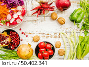 overhead view cherry tomatoes red chilies spring onion garlic lettuce parsley ripe pomegranate reddish walnut. Стоковое фото, агентство Ingram Publishing / Фотобанк Лори