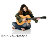 Beautiful woman isolated on white playing music with a guitar. Стоковое фото, агентство Ingram Publishing / Фотобанк Лори