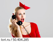 Beautiful fashion woman with a astonished expresion and holding a  vintage phone. Стоковое фото, агентство Ingram Publishing / Фотобанк Лори