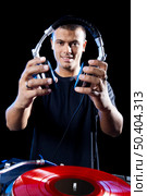 Portrait of a DJ playing disco electro music in a concert. Стоковое фото, агентство Ingram Publishing / Фотобанк Лори