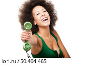 Afro-American young woman answering a call, isolated on white background. Стоковое фото, агентство Ingram Publishing / Фотобанк Лори