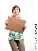 Beautiful woman with a sad face holding a cardboard, isolated over a white background. Стоковое фото, агентство Ingram Publishing / Фотобанк Лори