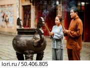 man woman with incense temple. Редакционное фото, агентство Ingram Publishing / Фотобанк Лори