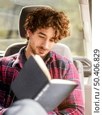 medium shot man reading car. Стоковое фото, агентство Ingram Publishing / Фотобанк Лори