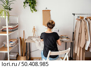 back view female tailor working studio. Стоковое фото, агентство Ingram Publishing / Фотобанк Лори