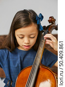 young cute girl learning how play cello. Стоковое фото, агентство Ingram Publishing / Фотобанк Лори