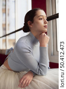 beautiful ballerina tutu skirt looking through window. Стоковое фото, агентство Ingram Publishing / Фотобанк Лори
