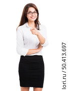 Beautiful hispanic business woman smiling with and pointing, over a white background. Стоковое фото, агентство Ingram Publishing / Фотобанк Лори